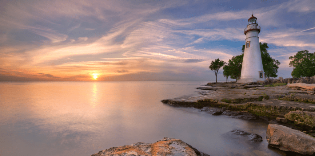 sunset over lake erie next to lighthouse